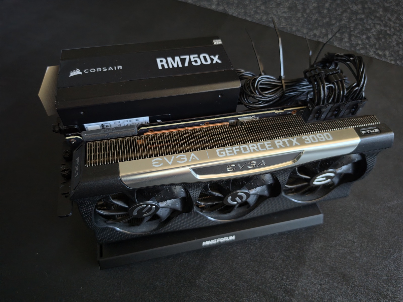 The parts going in: a full-size RTX 3090 and the power supply that feeds the external enclosure, staged before the build.